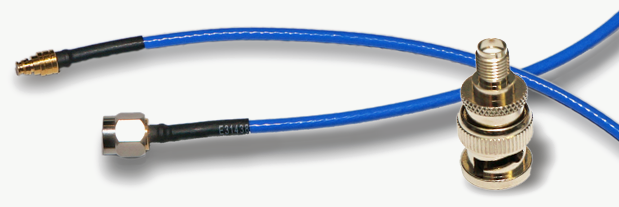 Blue RG178 cable with a gold SMP connector on one end and an SMA plug on the other, next to an SMA-to-BNC adapter.